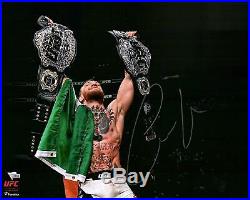 Conor McGregor UFC Signed 16 x 20 UFC 205 Raising Two Belts Spotlight Photo